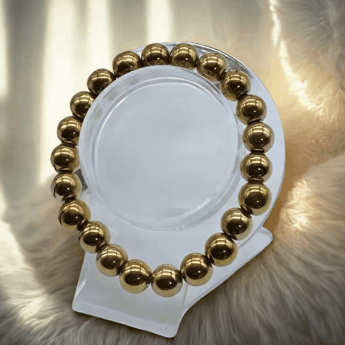 Elegant purple and gold gemstone bracelet set on display with intricate design and sparkling gemstones.