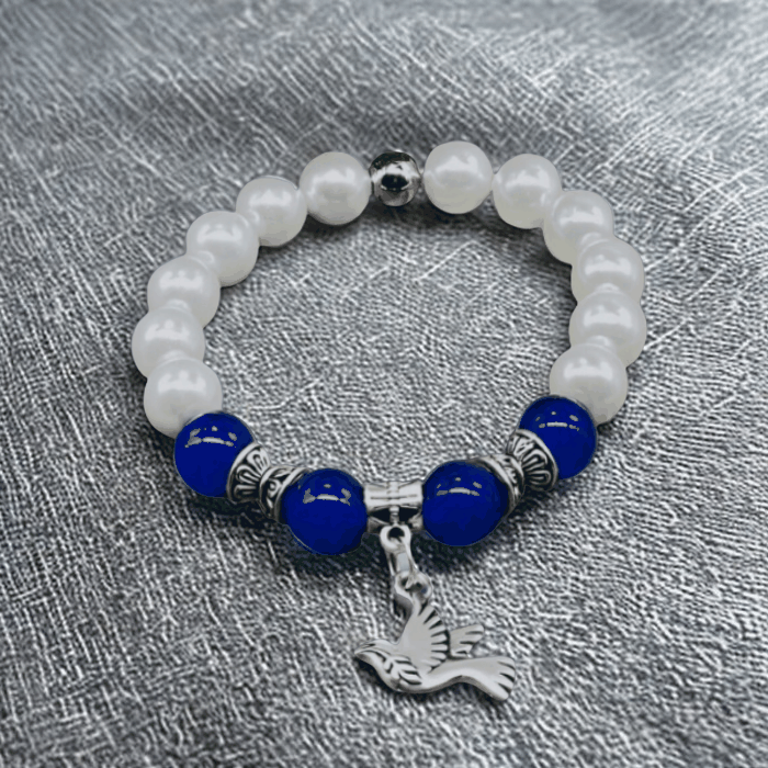 Blue jade and white glass pearl charm bracelet with a silver bird charm.