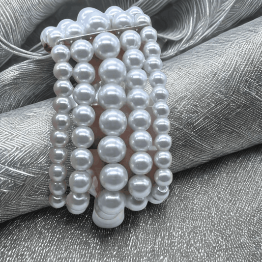 Multi Strand White Glass Pearl Stretch Bracelet with five intertwined strands on silky background.