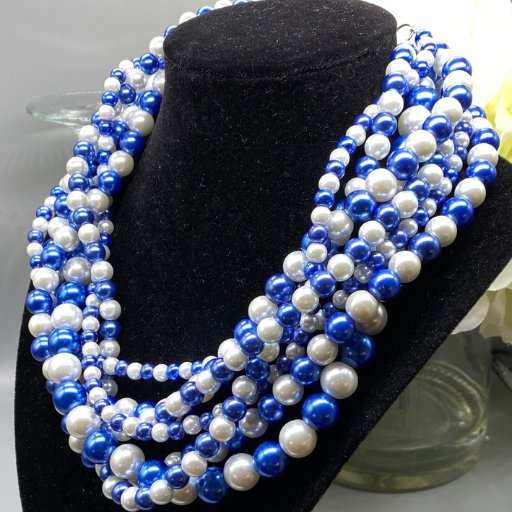 Royal Blue and White Glass Pearl 7 Strand Necklace on display bust.