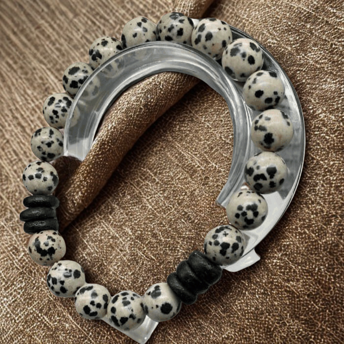 Dalmatian Gemstone Bracelet by Peace N Beads with spotted black and white beads on brown fabric