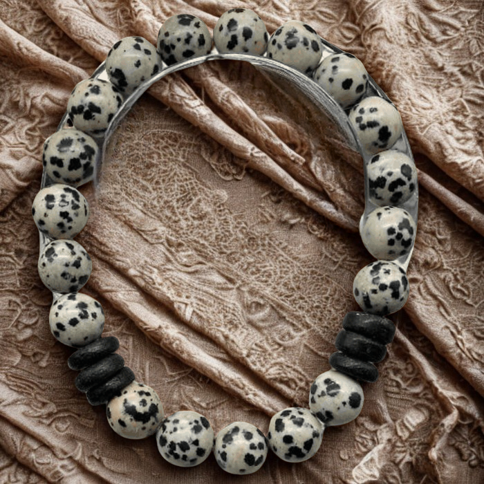 Peace N Beads Dalmatian Gemstone Bracelet with black and white spotted beads on fabric background
