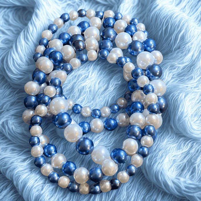5-Strand Royal Blue and White Pearl Stretch Bracelet by Peace N Beads on light blue fabric