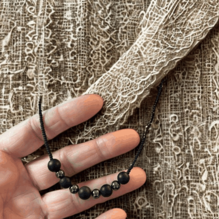 Hand holding Black Onyx and Hematite Gemstones Necklace from Peace N Beads Design with detailed beads