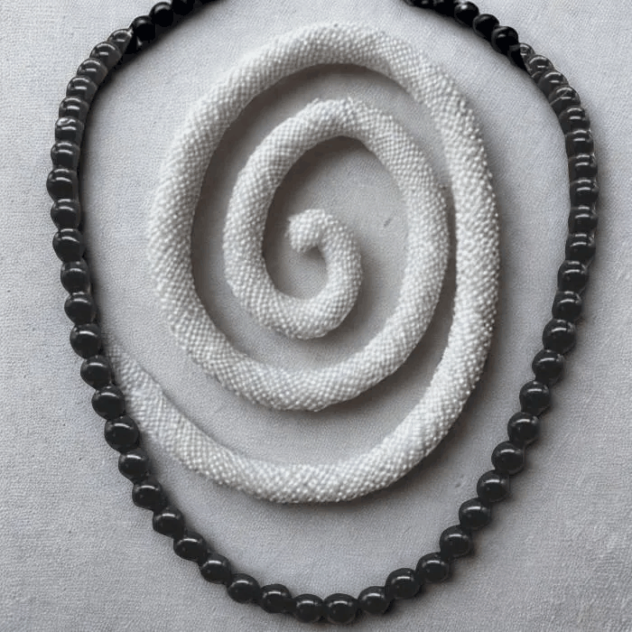 Peace N Beads Black Onyx Gemstone Necklace with polished round black beads on a gray background