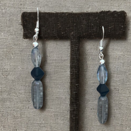 Blue and Black Crystal Bead Earrings by Peace N Beads Design displayed on a brown stand