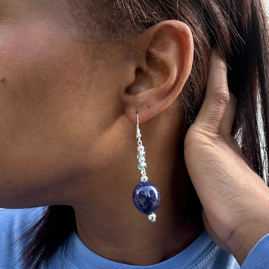 Blue Glass Crystal Drop Earrings hanging from ear, featuring a large blue glass bead with smaller clear crystals above