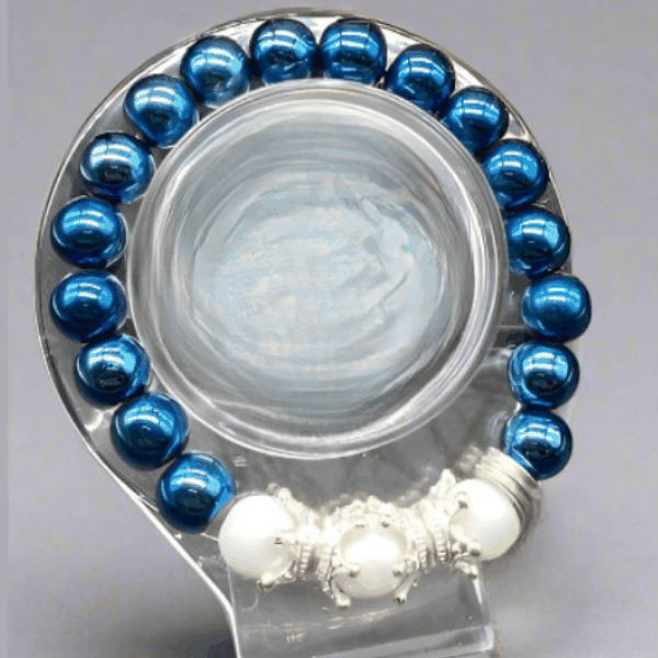 Peace N Beads Crown Blue Hematite Gemstone Bracelet with shiny blue and white beads on display