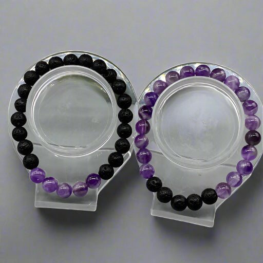 Peace N Beads Design Crown Chakra Bracelets with black lava and purple amethyst beads on clear display stands
