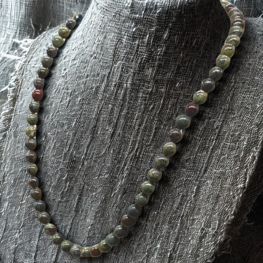 Dragon Blood Gemstone Necklace featuring vibrant round beads in earthy colors and elegant design