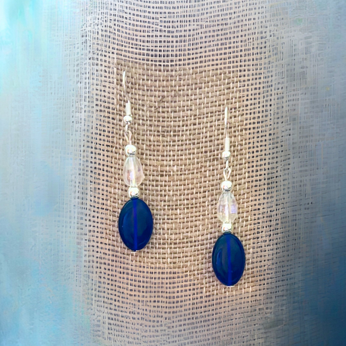Elegant Blue Acrylic Earrings with Glass Crystals by Peace N Beads Design hanging on textured fabric
