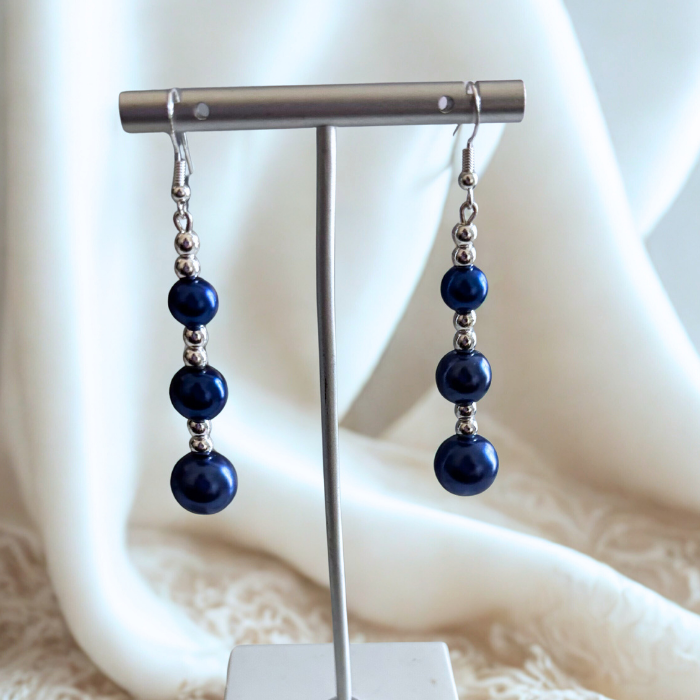 Elegant Hematite and Blue Glass Pearl Drop Earrings displayed on a silver stand with white background