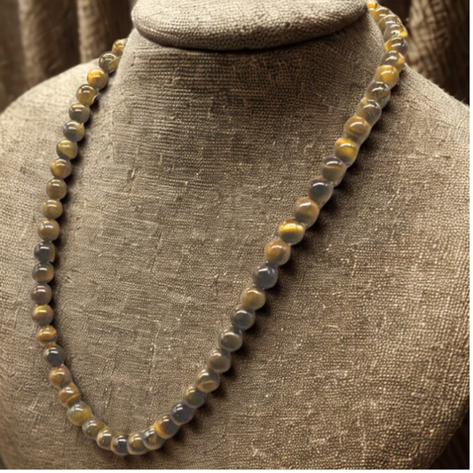 Feel Empowered with a Tiger Eye Necklace by Peace N Beads showing polished round tiger eye beads on a display bust