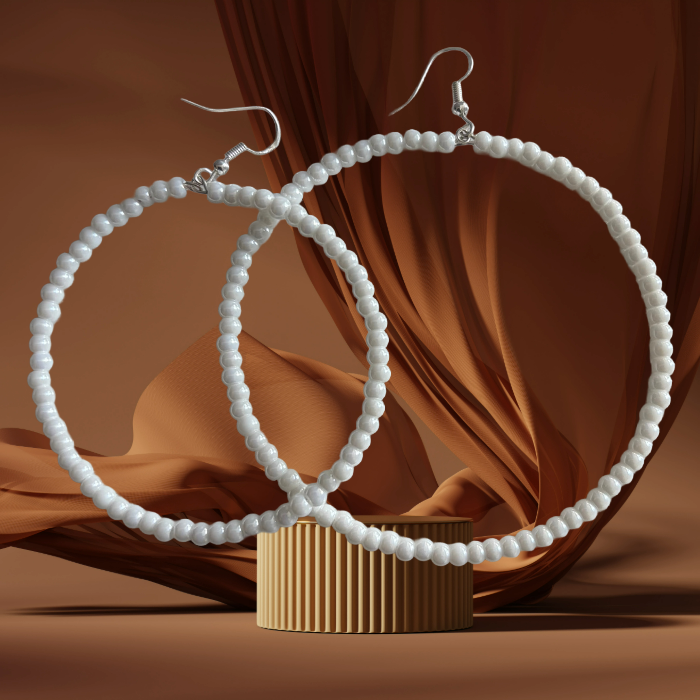 Glamorous Oversized Hoops Peace N Beads white beaded earrings with silver hooks on brown fabric background