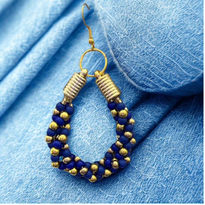 Gold Accented Twisted Royal Blue and Gold Hoop Earrings by Peace N Beads on textured blue fabric2