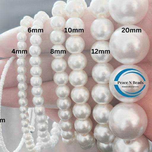 Pearl beads in various sizes from 4mm to 20mm held in hand by Peace N Beads