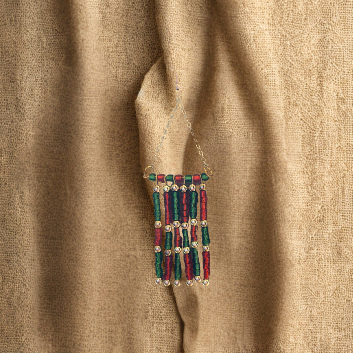 Colorful Handmade Drop Earrings with Beaded Design and Gold Accents Hanging on Fabric