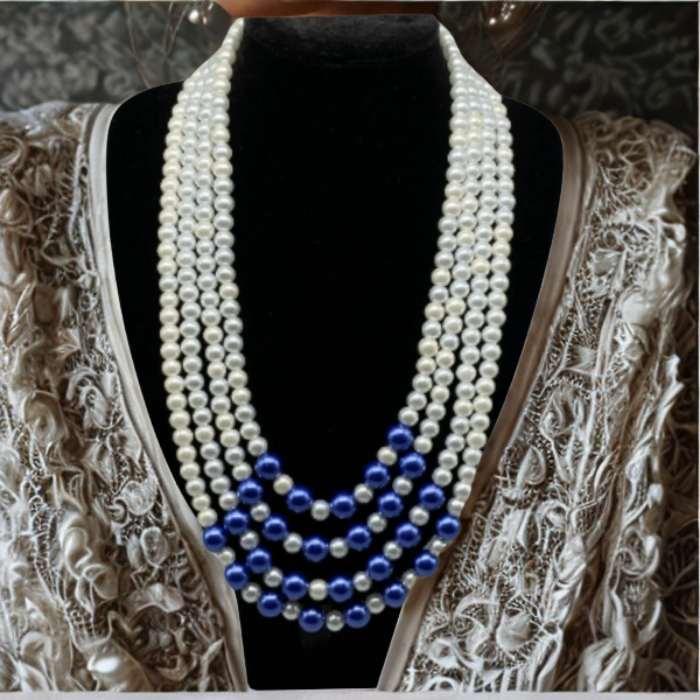 Handmade Royal Blue and White 4 Strand Pearl Necklace displayed on a black bust with intricate fabric background