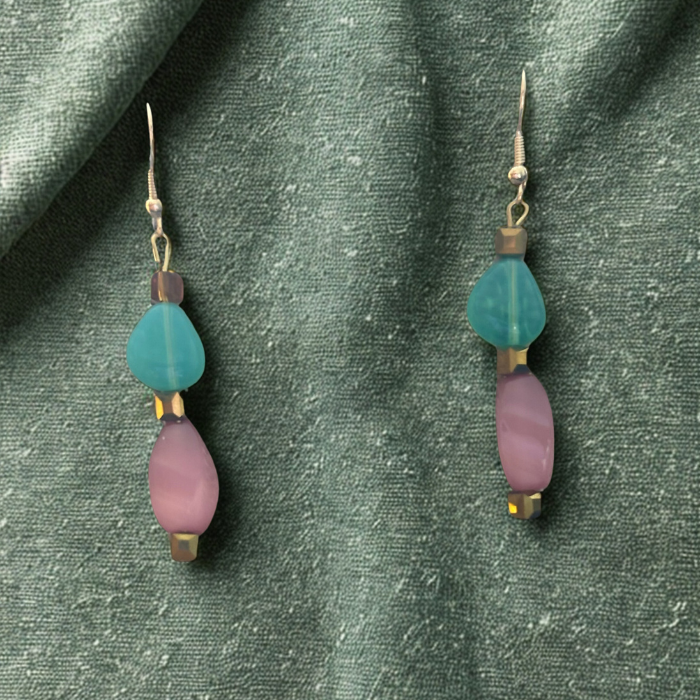 Pink and Green Drop Earrings by Peace N Beads Design featuring pastel beads on textured green fabric background
