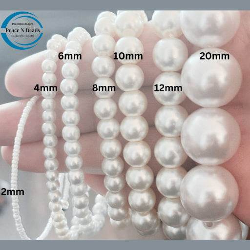 Various sizes of white pearl beads from Peace N Beads displayed for Regal Three-Layer Royal Blue Pearl Necklace