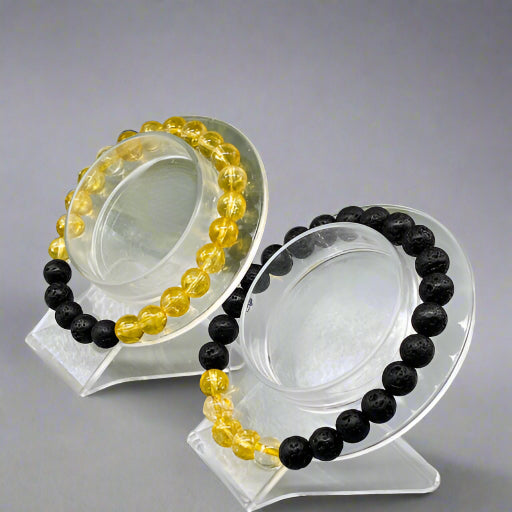 Peace N Beads Design solar plexus chakra bracelets with yellow and black beads on clear display stands