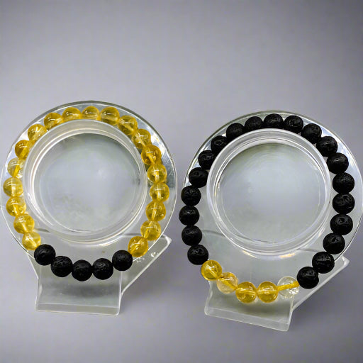 Peace N Beads Design solar plexus chakra bracelets with yellow and black bead combination on clear display stands