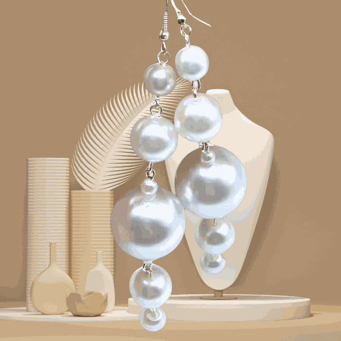 Unique White Glass Pearl Dangle Earrings by Peace N Beads displayed on beige background with decorative vases