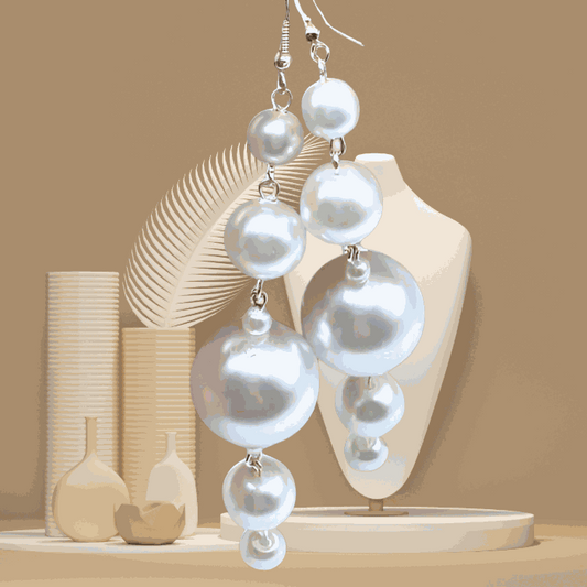 Unique White Glass Pearl Dangle Earrings by Peace N Beads displayed on beige background with decorative vases