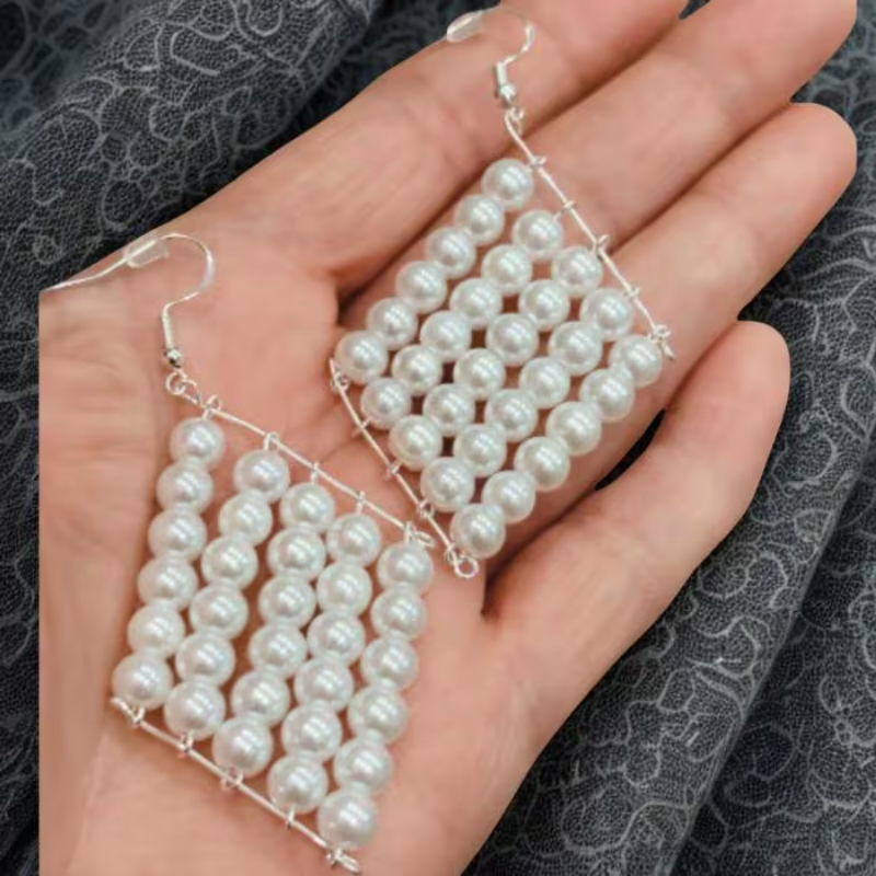 Peace N Beads White Glass Pearl Retanglar Earrings displayed on hand with silver wire frame