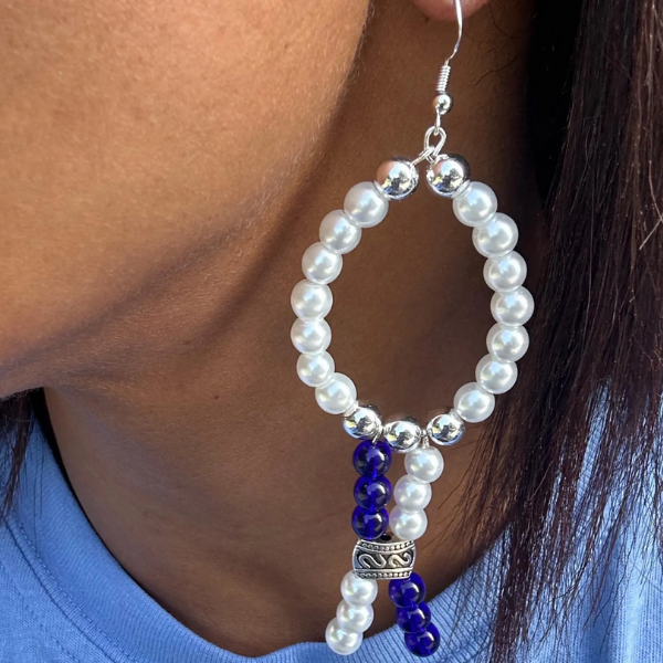 Peace N Beads White Oval Drop Earrings with pearls and blue bead accents on a model
