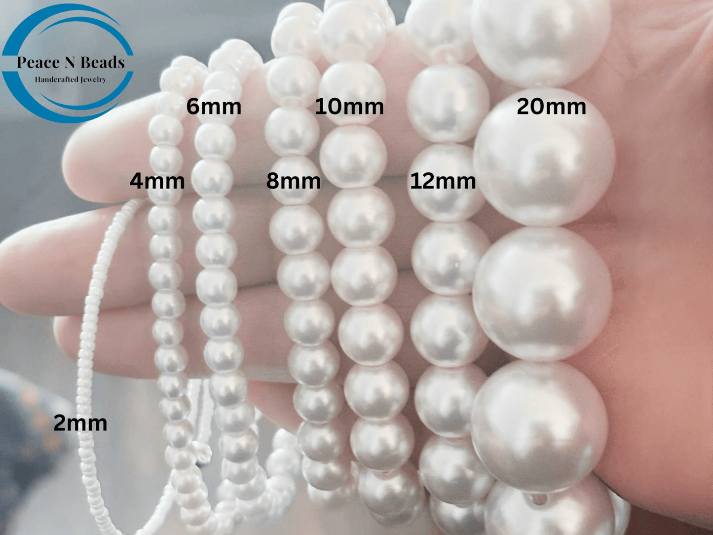 Elegant twisted royal blue and white glass pearl necklace showcasing various pearl sizes in a multi-layer strand design.