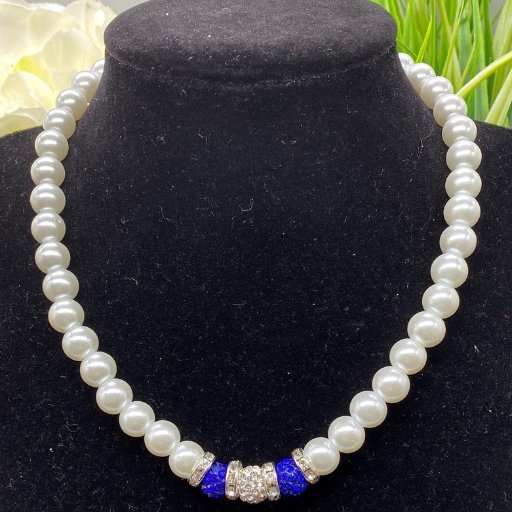 Royal Blue Rhinestone and White Glass Pearls Necklace displayed on black jewelry stand by Peace N Beads