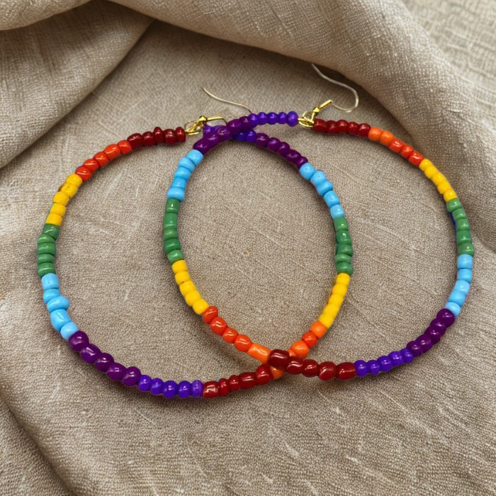 Peace N Beads Vibrant Rainbow Hoop Earrings with multicolor beads and gold hooks on fabric background