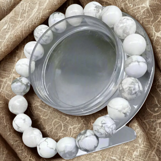 Serene Howlite Gemstone Bracelet displayed elegantly with a smooth finish on a decorative stand