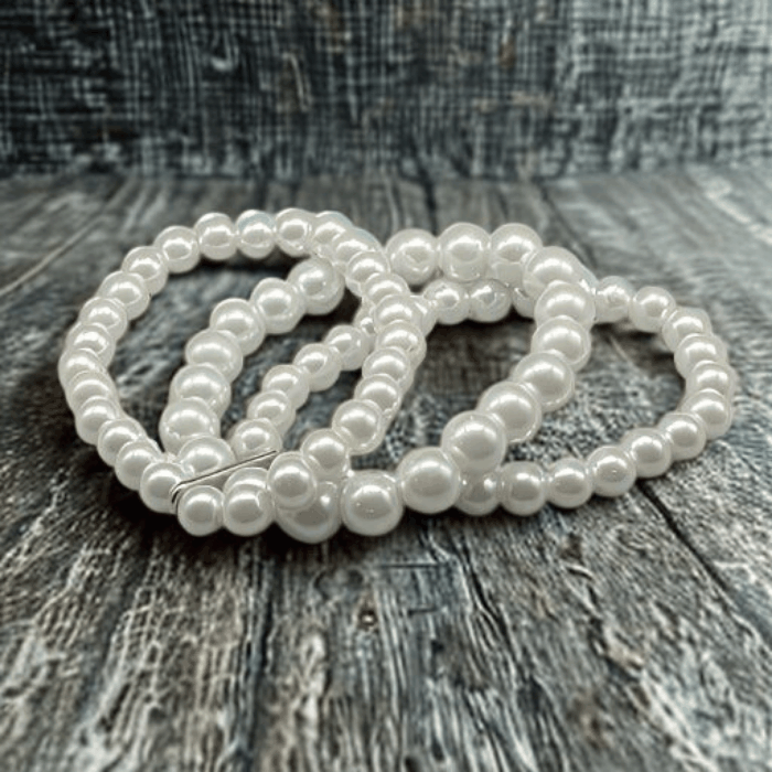 Customizable White Glass Pearl Stretch Bracelet on wood surface.