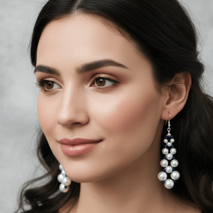 Model showcasing 4 Inch Drop White Glass Pearl and Blue Crystal Earrings for elegant occasions
