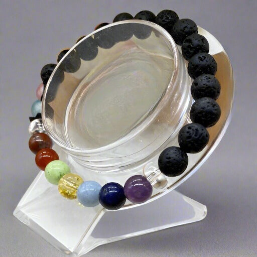 7 Beaded Lava Rock Chakra Bracelet displayed on a clear stand showcasing vibrant beads for energy healing