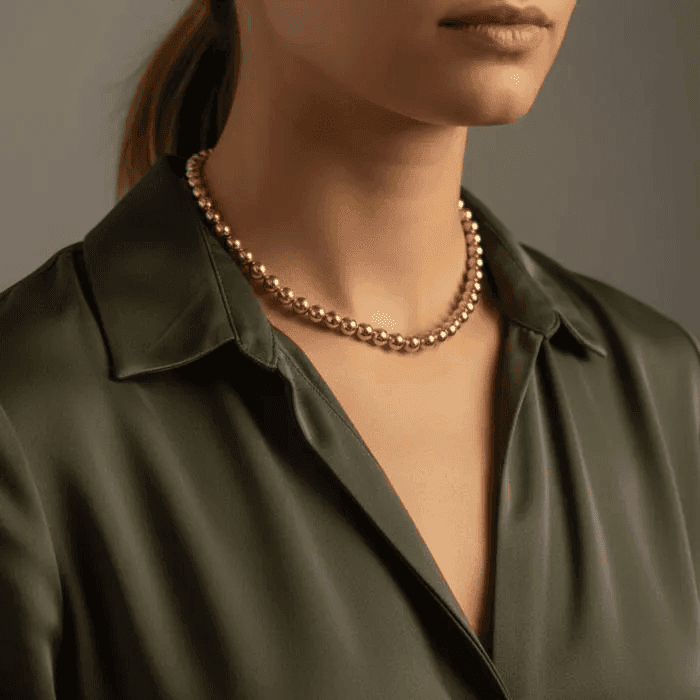 Elegant Gold Hematite Gemstone Necklace worn on a model with stylish blouse