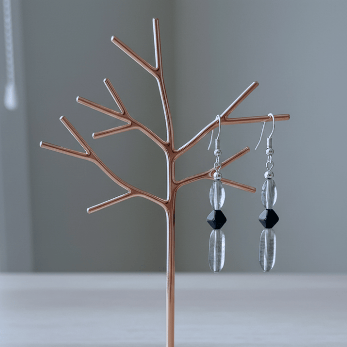 Elegant Blue and Black Crystal Bead Earrings displayed on a modern branching stand