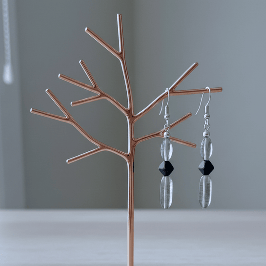 Elegant Blue and Black Crystal Bead Earrings displayed on a modern branching stand