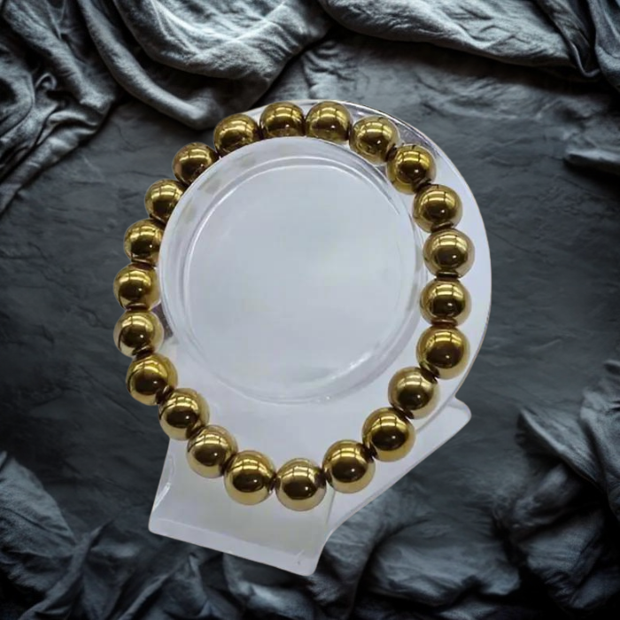 Elegant Purple and Gold Gemstone Bracelet Set displayed on a clear stand against textured background