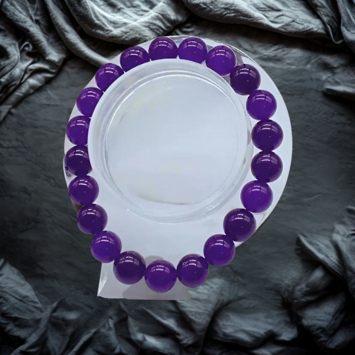 Elegant Purple and Gold Gemstone Bracelet Set with various colorful beads on a textured background
