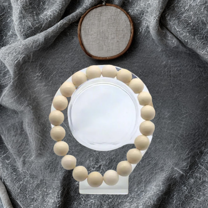 Elevate Your Style with the Red Coral and Cream Fossil Bracelet Set displayed on a clear stand