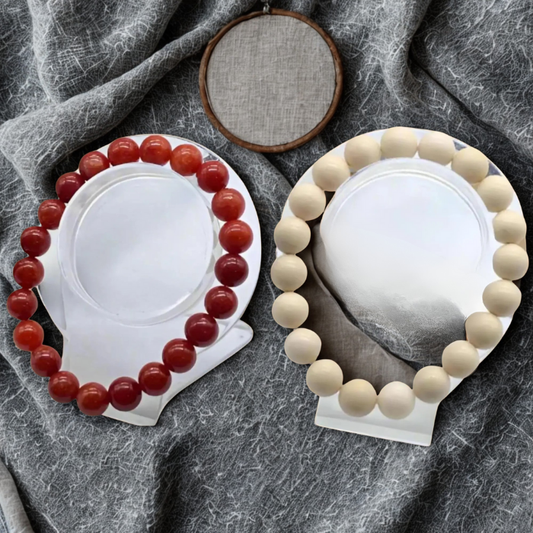 Elevate Your Style with the Red Coral and Cream Fossil Bracelet Set displayed on a textured background