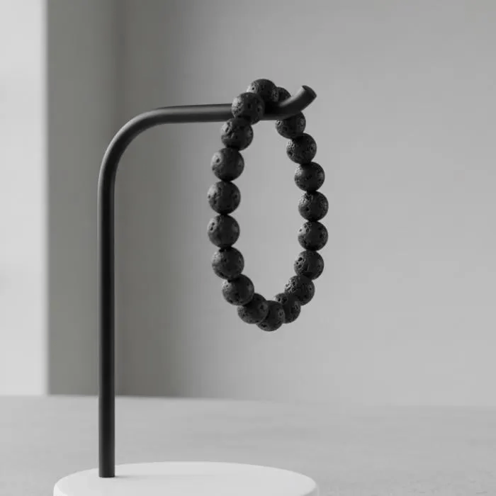 Genuine Black Lava Rock Beaded Bracelet displayed on a minimalist stand for a modern look