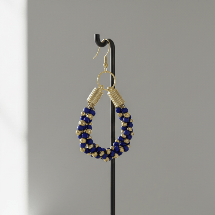 Gold Accented Twisted Royal Blue and Gold Hoop Earrings elegantly displayed on a stand
