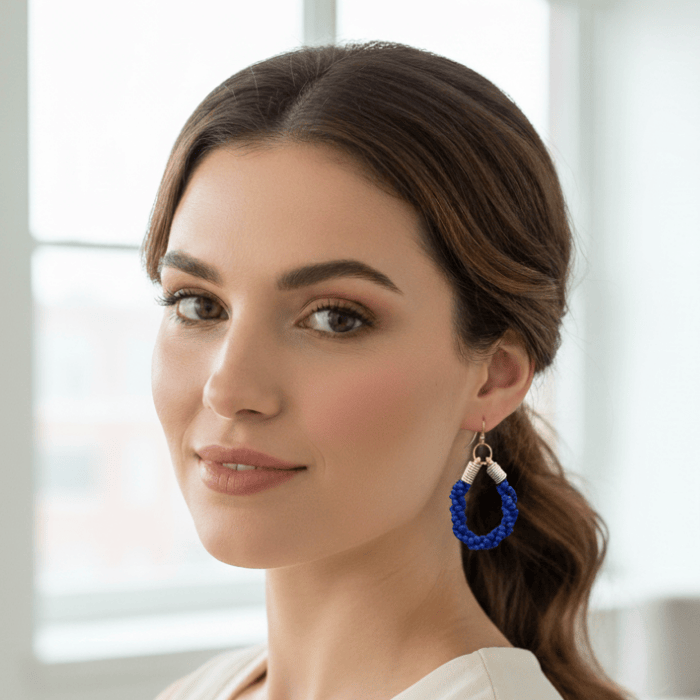 Gold Accented Twisted Royal Blue and Gold Hoop Earrings worn by a model, showcasing elegance and style