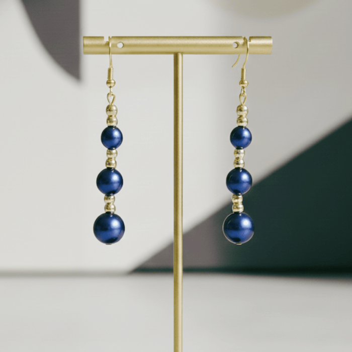 Hematite and Blue Glass Pearl Drop Earrings featuring elegant gold accents for a stylish look