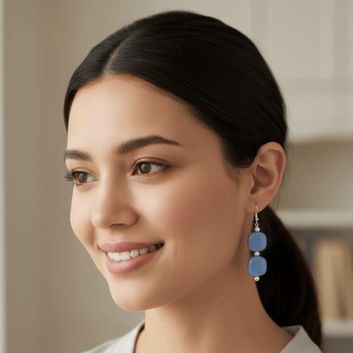 Stylish Light Blue and White Drop Earrings hanging elegantly on a model's ear