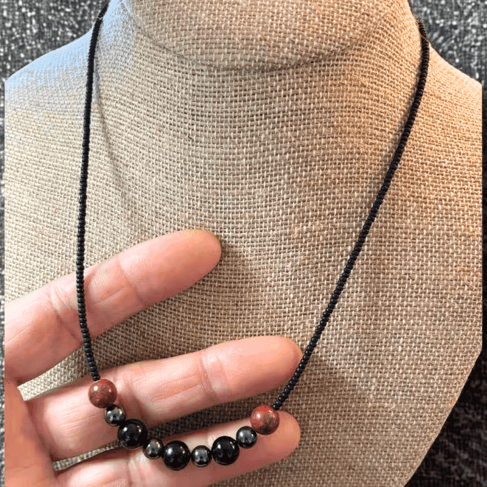 Minimalist Spiritual Protection Necklace featuring black and red beads on a simple cord design